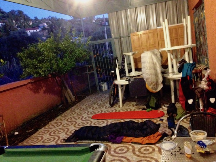 Nico and Dan's empty camping mats, sitting amongst various bar furniture (chairs, tables, pool table), underneath a canopy. The area is open to the sky at the side.
