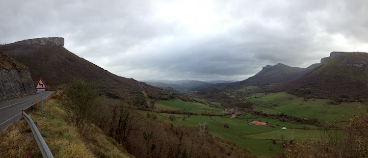 View from a road in the Cantabrian Mountains, Spain, of a valley that trails off into the distance and fills with grey clouds