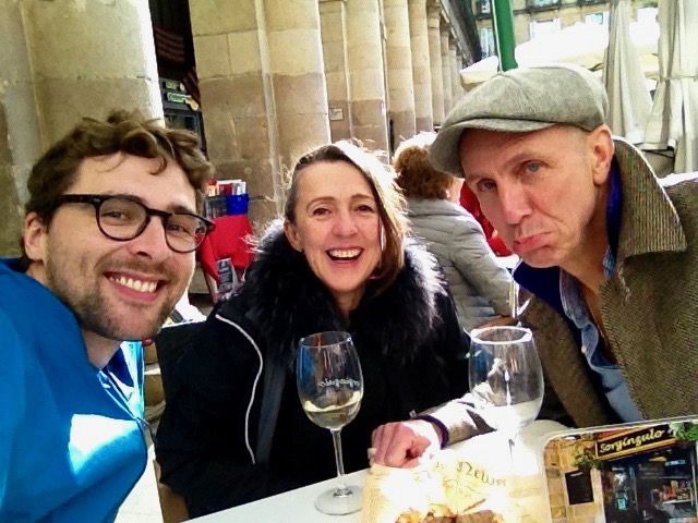 Dan, his mum and her boyfriend, Tim, smiling at a table in the main square of the old town in Bilbao, Spain (Tim is not smiling)