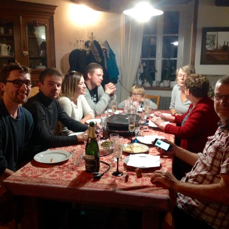 Sitting at the table with Gaby's family, about to eat a Raclette meal