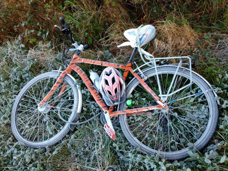My tiger bike, lying on the grass, with a white layer of frost all over it. The grass is also frosty.