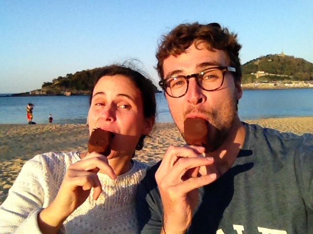 Joana and Dan on the beach in San Sebastián, with Magnum ice creams in their mouths