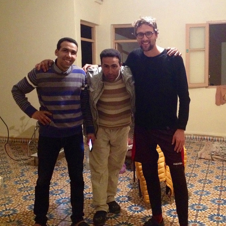 Mustafa, Abdellah and Dan, posing for a photo in a large, but mostly empty room.