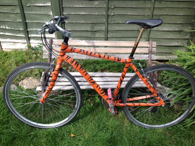 Bike painted orange with black stripes like a tiger